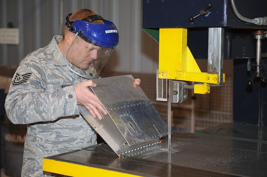 Tech. Sgt. Matthew Wildman, 4th Equipment Maintenance Squadron aircraft structural maintenance craftsman, cuts simulated damage into an aircraft structure during on-the-job training on Seymour Johnson Air Force Base, N.C., Feb. 3, 2010. Wildman is adding damage to the part for training purposes so new Airmen can demonstrate how to repair it and qualify for upgrade to a five-skill level. Wildman is from St. Louis. (U.S. Air Force photo/Senior Airman Ciara Wymbs)   