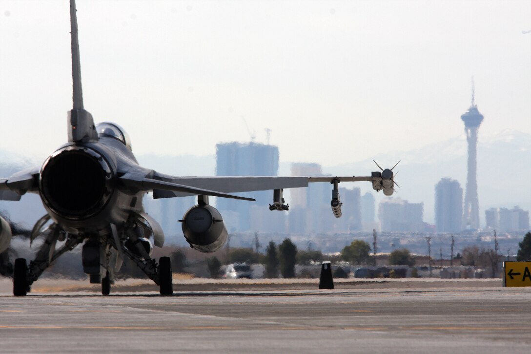 An F-16 prepares to takeoff for a training mission as it leaves the city of Las Vegas in its wake. Two of the F-16 units, Homestead Air Reserve Base and Naval Air Station Joint Reserve Base Forth Worth, Texas, are here for the two-week long aerial combat training exercise, Red Flag. (U.S. Air Force photo/ Tech. Sgt. Bucky Parrish)