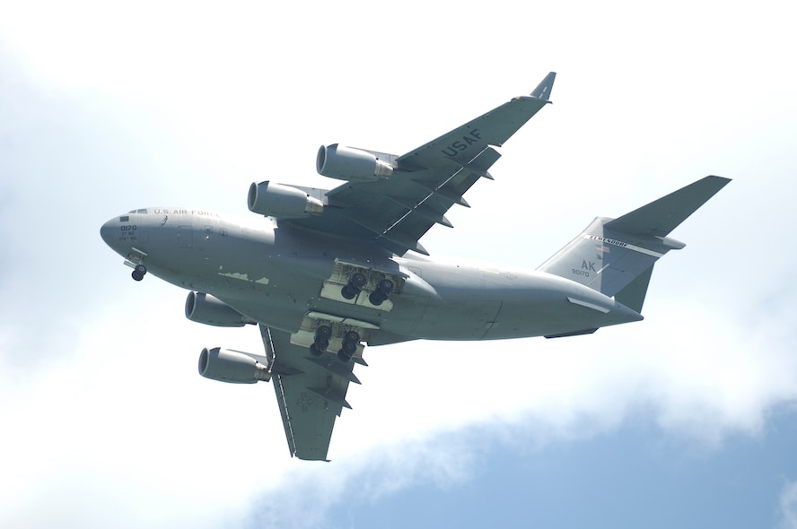 A C-17 Globemaster III conducts a flyover above the 2010 Singapore Airshow held at Changi Airport on Feb. 3.  Air Force officials announced March 12 that the 445th Airlift Wing at  Wright-Patterson Air Force Base, Ohio, will soon begin to replace its fleet of C-5s with the newer C-17. (Department of Defense photo/Tech Sgt. Cohen A. Young) 
