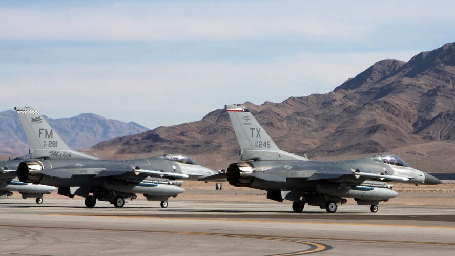 F-16s from Homestead Air Reserve Base, Fla., and Naval Air Station Joint Reserve Base Forth Worth, Texas, taxi onto the runway of Nellis Air Force Base, Nev., for the two-week long aerial combat training exercise, Red Flag. It is the first time in 16 years both units have participated in the training. (U.S. Air Force photo/ Tech. Sgt. Bucky Parrish)
