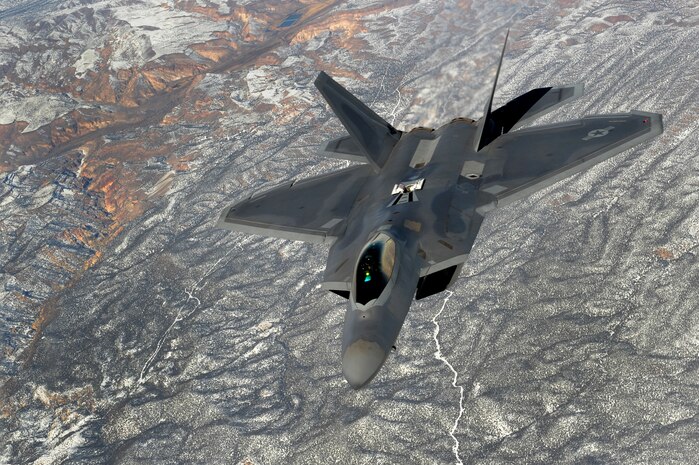 NELLIS AIR FORCE BASE, Nev. -- An  F-22 Raptor from the 90th Fighter Squadron Elmendorf Air Base, Alaska flies  over snow covered Nevada mountains on its way to the Nevada Test and Training Range during Red Flag 10-2 Feb. 4, 2010. Red Flag is a realistic training exercise involving the air forces of the United States and its allies. The exercise is conducted on the 15,000-square-mile Nevada Test and Training Range, north of Las Vegas. (U.S Air Force photo/ Staff Sgt Taylor Worley/RELEASED)