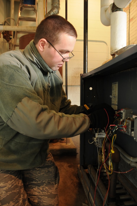 Airman 1st Class Zane Miller, 316th Civil Engineer Squadron heating, ventilation and air conditioning technician, checks the status of a boiler on Joint Base Andrews, Md., Jan. 27, 2010. Though HVAC by name covers three key components facility maintenance, the mission of the flight encompasses a wide range of responsibilities. (U.S. Air Force photo by Chelsea Gitzen)