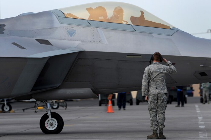 Airman 1st Class Justin Horne, assigned to the 49th Aircraft Maintenance Squadron, renders a salute to a F-22 Raptor pilot during Red Flag 10-2 at Nellis Air Force Base, Nev., Feb. 4, 2010. Red Flag is a realistic combat training exercise involving the air forces of the United States and its allies. The exercise is conducted on the 15,000-square-mile Nevada Test and Training Range, north of Las Vegas.(U.S. Air Force photo by Airman 1st Class Brett Clashman/RELEASED)