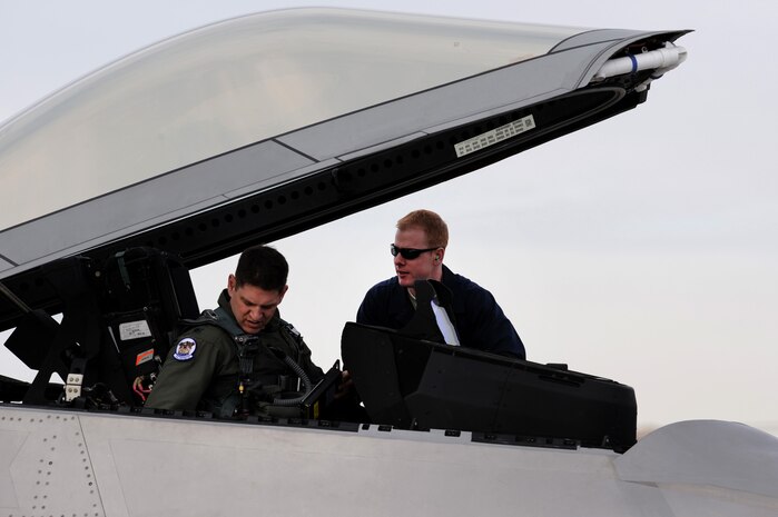 Lt. Col. Joe Kunkel, assigned to the 525th Fighter Squadron, and Staff Sgt. Randall Woode, assigned to the 49th Aircraft Maintenance Squadron, perform a pre-flight check in a F-22A Raptor during Red Flag 10-2 at Nellis Air Force Base, Nev., Feb. 4, 2010. Red Flag is a realistic combat training exercise involving the air forces of the United States and its allies. The exercise is conducted on the 15,000-square-mile Nevada Test and Training Range, north of Las Vegas.(U.S. Air Force photo by Airman 1st Class Brett Clashman/RELEASED)