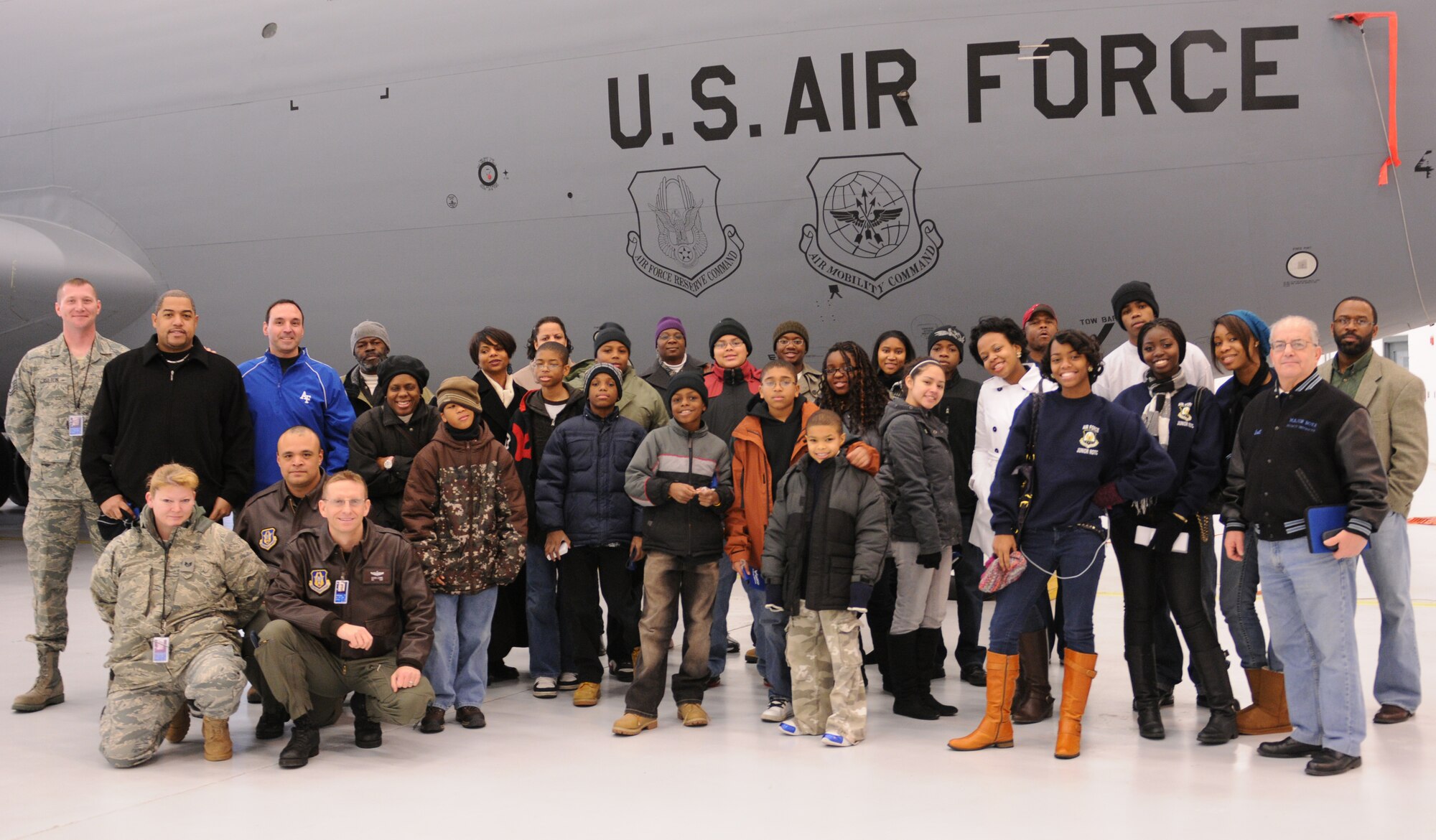 Servicemembers (from left to right) standing - Master Sgt. Richard Carlton, 459 MXS/ISO, crew chief, kneeling - Staff Sgt. Catherine Jordan, 459 MXS/AGE, TSgt. Chris Oshoa, 756 ARS, boom operator and Maj. Derek Levine, 756 ARS, pilot are posing with (left to right) Jerri Walsh of Patriots Technology Training Center and Lt. Col. Cris Marchiori, Air Force Academy addmissions counseling representative, Maj. (ret.) Sal Bova, JROTC.