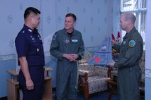 Lt. Col. Corey L. Steinbrink, mission commander (center), and Chief Master Sgt. James D. Riley, chief loadmaster (right), with the Air Force Reserve’s 302nd Airlift Wing, present Special Group Captain (Brig Gen equivalent) Thawonwat Chantanagama, Deputy Director, Director of Operations, Royal Thai Air Force, with a replica tail flash to recognize completion of Modular Airborne Firefighting System training.  The bright orange number “5” on the tail flash signifies the MAFFS unit number flown in the aircraft.  More than 50 members of the RTAF attended the 302 AW-led training to increase their proficiency with the MAFFS system.  Seven 302 AW members traveled to Thailand to provide expert training on safe and effective C-130 MAFFS operations.  This event marks the first time the Air Force Reserve has sent delegates to train a foreign Air Force on use of the MAFFS equipment.  (U.S. Air Force photo/Capt. Jody L. Ritchie)