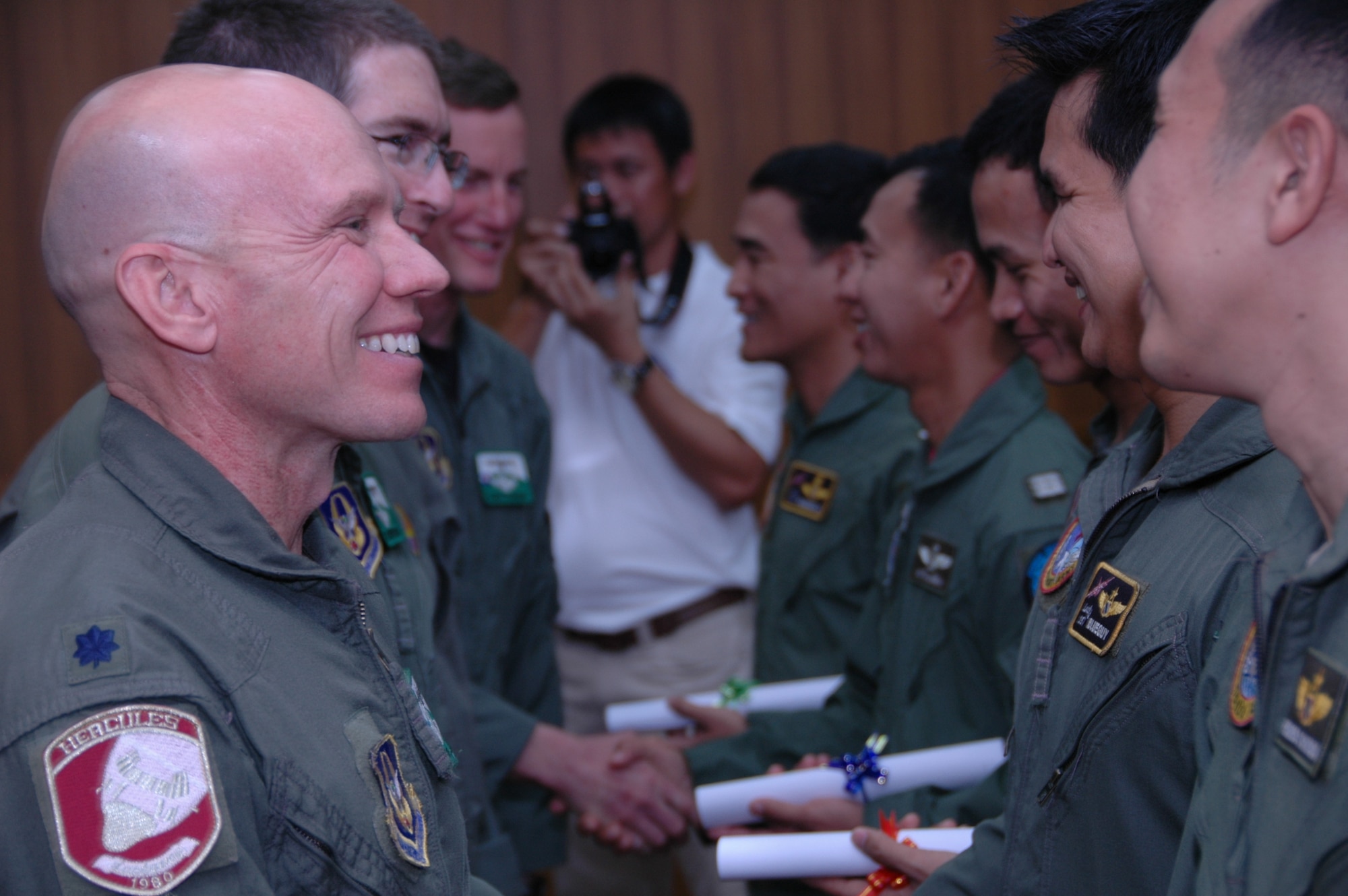 AF Reservist Lt. Col. James M. Steward, C-130 pilot and chief of flying safety, 302nd Airlift Wing, congratulates a member of the Royal Thai Air Force upon completion of Modular Airborne Firefighting System training.   More than 50 members of the RTAF attended the 302 AW-led training to increase their proficiency with the MAFFS system.  Seven member of the Air Force Reserve’s 302 AW traveled to Thailand to provide expert training on safe and effective C-130 MAFFS operations.  This event marks the first time the Air Force Reserve has sent delegates to train a foreign Air Force on use of the MAFFS equipment.  (U.S. Air Force photo/Capt. Jody L. Ritchie)