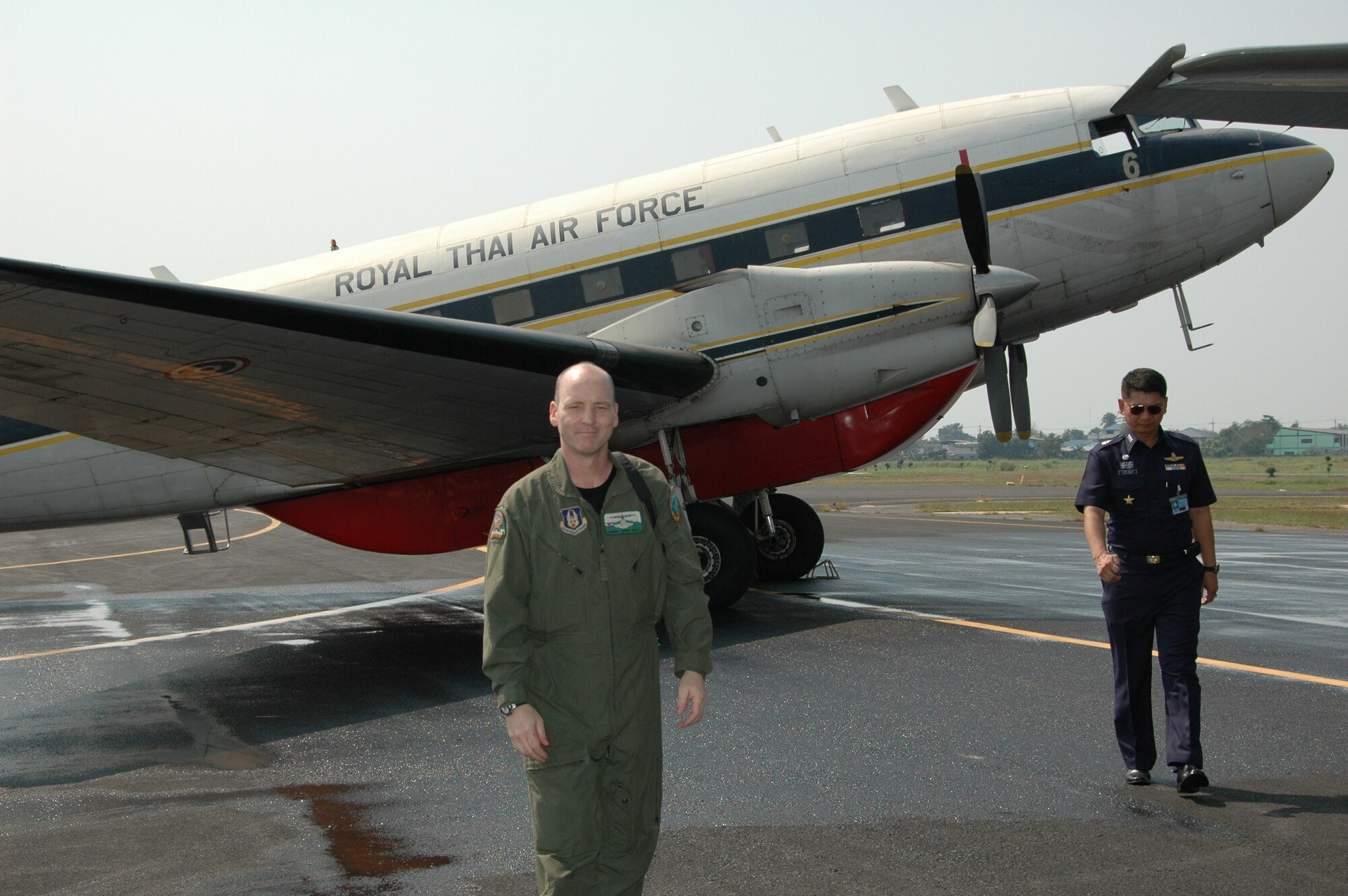 Chief Master Sgt. James D. Riley, chief loadmaster with the Air Force Reserve’s 302nd Airlift Wing steps away from a PT-47, a modified version of the DC-3 at Phitsanulok Royal Thai Air Force Base, Thailand.  As a child, Chief Riley visited the same aircraft with his Thai neighbor.  The Chief returned to Thailand as one of seven members of the Air Force Reserve’s 302 AW, based at Peterson AFB, Colo. to provide expert training to RTAF members on safe and effective C-130 MAFFS operations.  This event marks the first time the Air Force Reserve has sent delegates to train a foreign Air Force on use of the MAFFS equipment. (U.S. Air Force photo/Capt. Jody L. Ritchie)