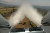 Water is released from a Royal Thai Air Force C-130 equipped with the Modular Airborne Firefighting System over north central Thailand during MAFFS training.  Members of the RTAF are certifying their proficiency on the MAFFS missions with assistance from the Air Force Reserve’s 302nd Airlift Wing based at Peterson AFB, Colo.  Seven 302 AW members traveled to Thailand to provide expert training on safe and effective C-130 MAFFS operations.  This event marks the first time the Air Force Reserve has sent delegates to train a foreign Air Force on use of the MAFFS equipment. (U.S. Air Force photo/Capt. Jody L. Ritchie)
