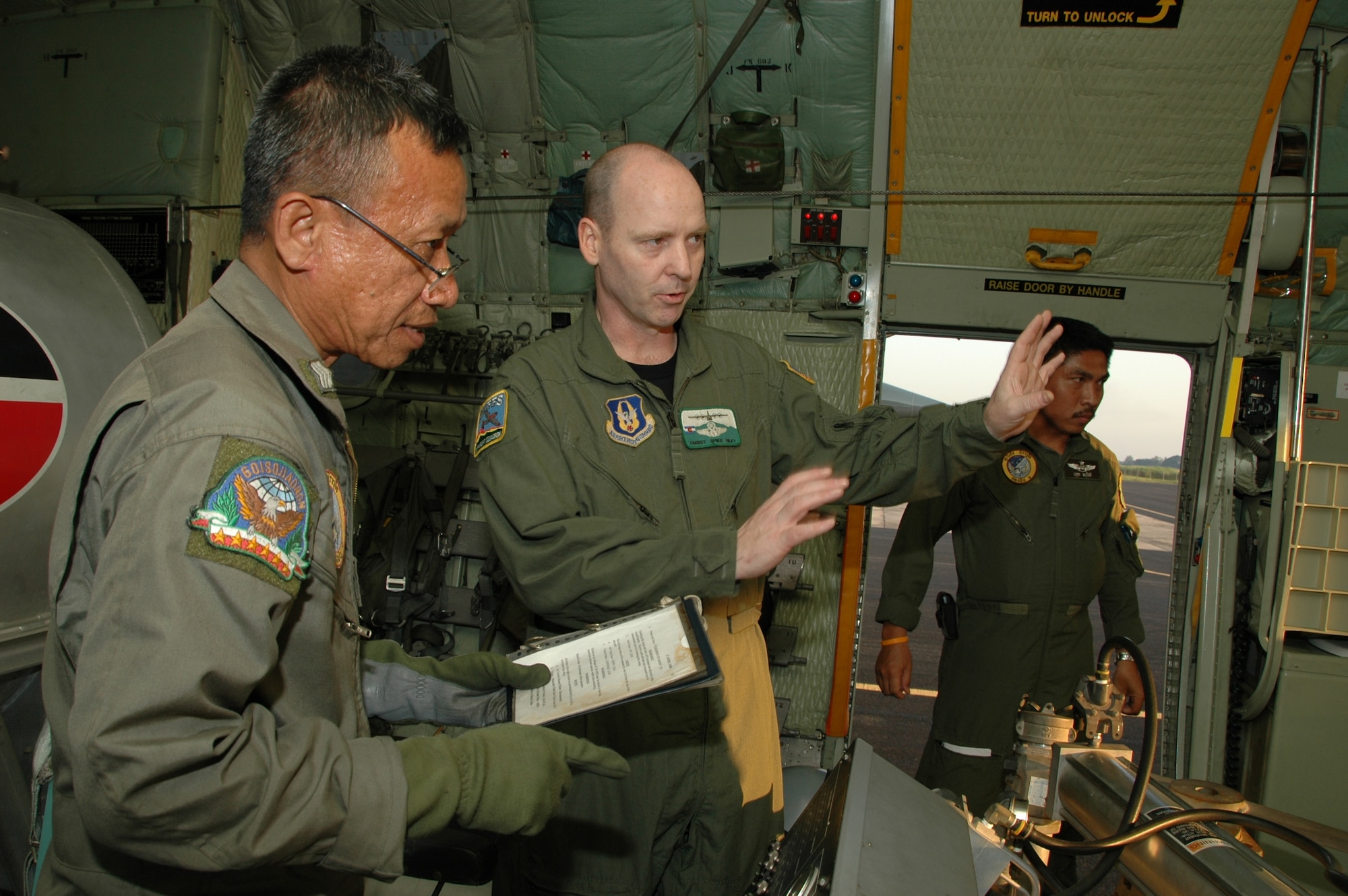 Chief Master Sgt. James D. Riley, chief loadmaster with the Air Force Reserve’s 302nd Airlift Wing discusses the Modular Airborne Firefighting System emergency procedures with Royal Thai Air Force loadmasters at Phitsanulok Royal Thai Air Force Base, Thailand.   Seven members of the Air Force Reserve’s 302 AW, based at Peterson AFB, Colo. were in Thailand providing expert training to RTAF members on safe and effective C-130 MAFFS operations.  This event marks the first time the Air Force Reserve has sent delegates to train a foreign Air Force on use of the MAFFS equipment. (U.S. Air Force photo/Capt. Jody L. Ritchie)