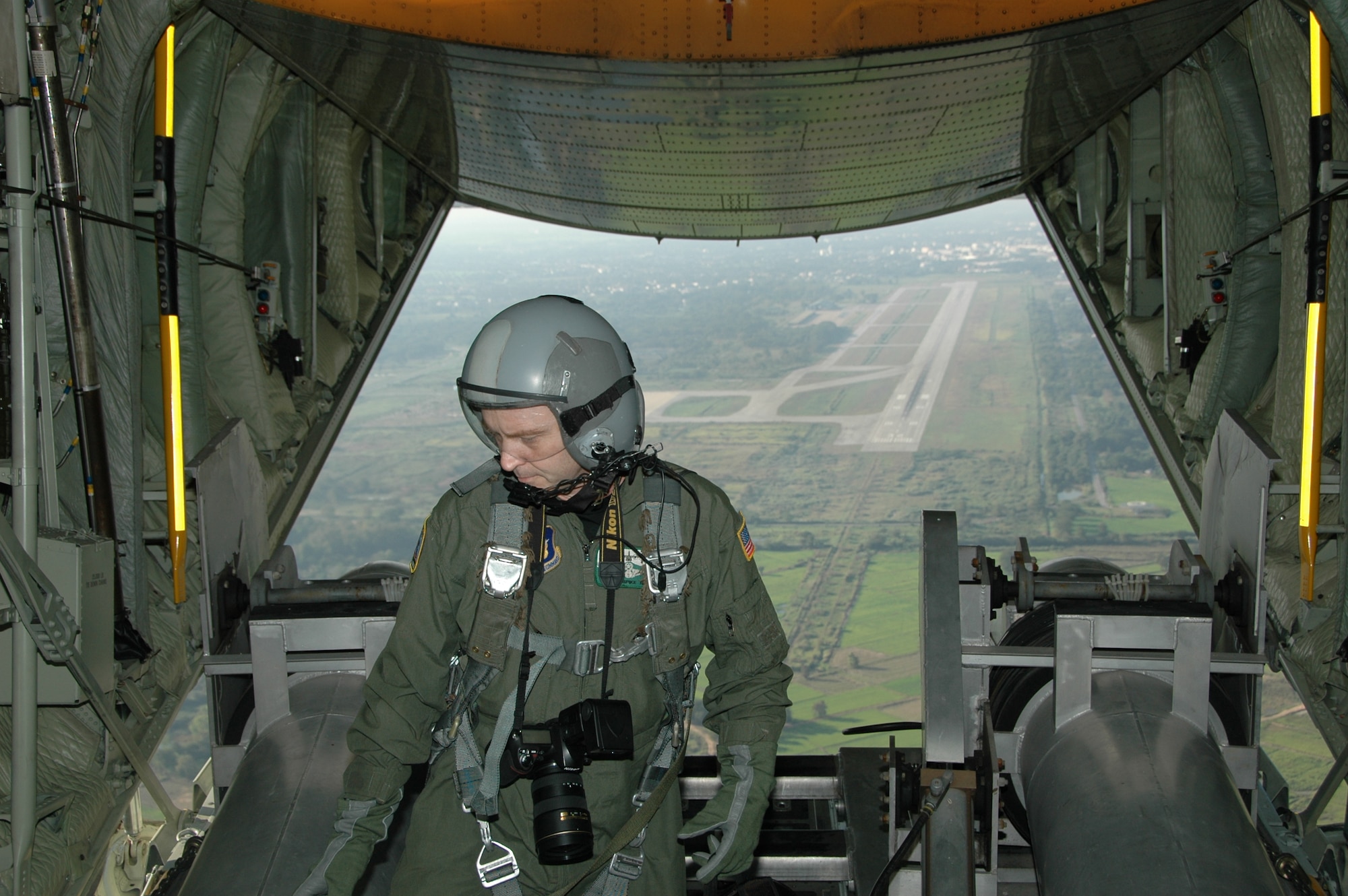 Chief Master Sgt. James D. Riley, chief loadmaster with the Air Force Reserve’s 302nd Airlift Wing prepares to pull in the Modular Airborne Firefighting System tubes after take-off from the Phitsanulok Royal Thai Air Force Base, Thailand.   Seven members of the Air Force Reserve’s 302 AW, based at Peterson AFB, Colo. were in Thailand providing expert training to RTAF members on safe and effective C-130 MAFFS operations.  This event marks the first time the Air Force Reserve has sent delegates to train a foreign Air Force on use of the MAFFS equipment. (U.S. Air Force photo/Capt. Jody L. Ritchie)