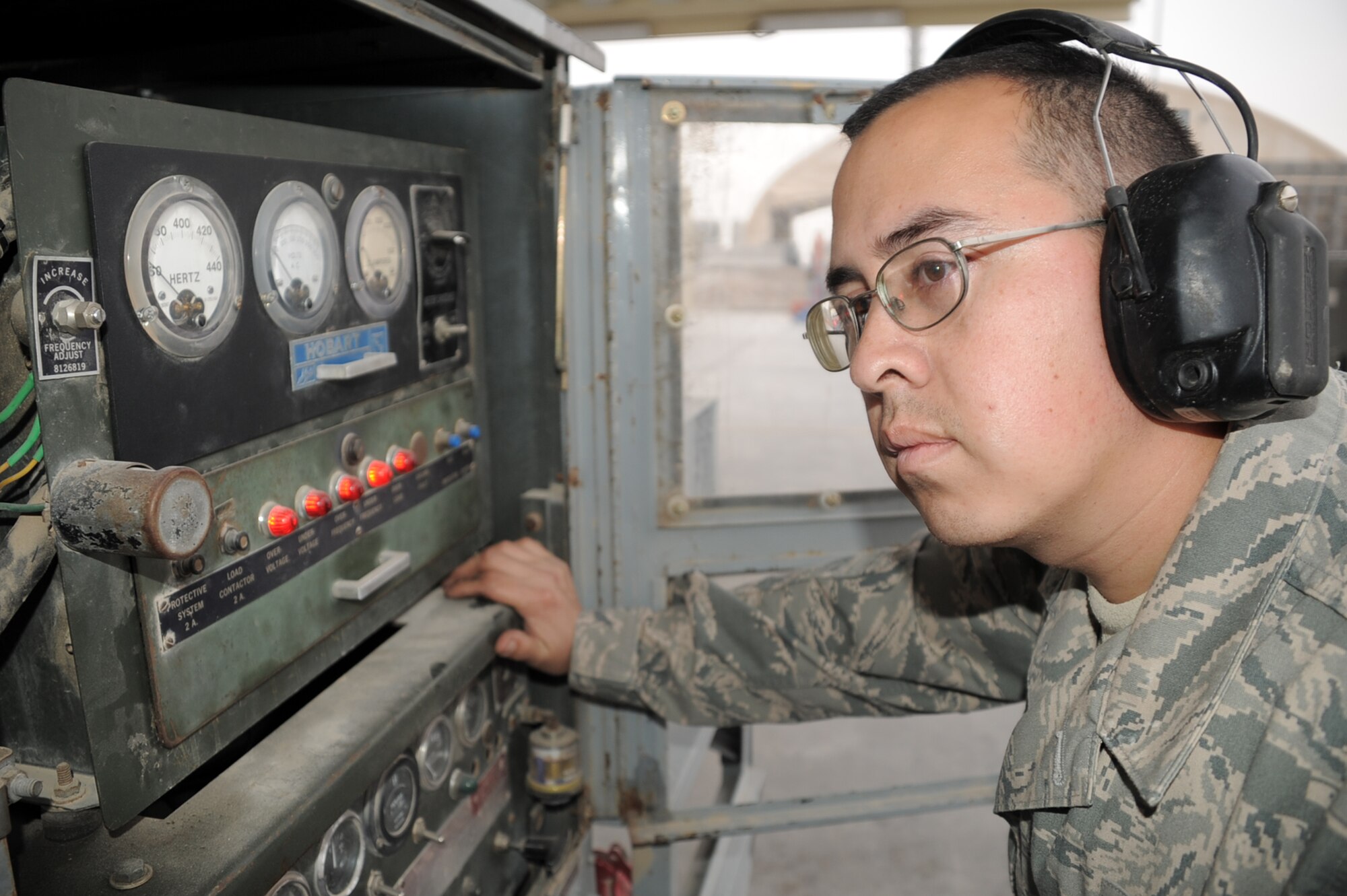 Staff Sgt. Efrem Flores, aerospace ground equipment craftsmen with the 380th Expeditionary Maintenance Squadron, works on a piece of AGE equipment at his unit at a non-disclosed base in Southwest Asia on Feb. 5, 2010. In his deployed duties, Sergeant Flores maintains to support aircraft systems or subsystems and manages AGE functions and activities. He is deployed from the 374th Maintenance Squadron at Yokota Air Base, Japan, and his hometown is San Antonio, Texas.  (U.S. Air Force Photo/Master Sgt. Scott T. Sturkol/Released)