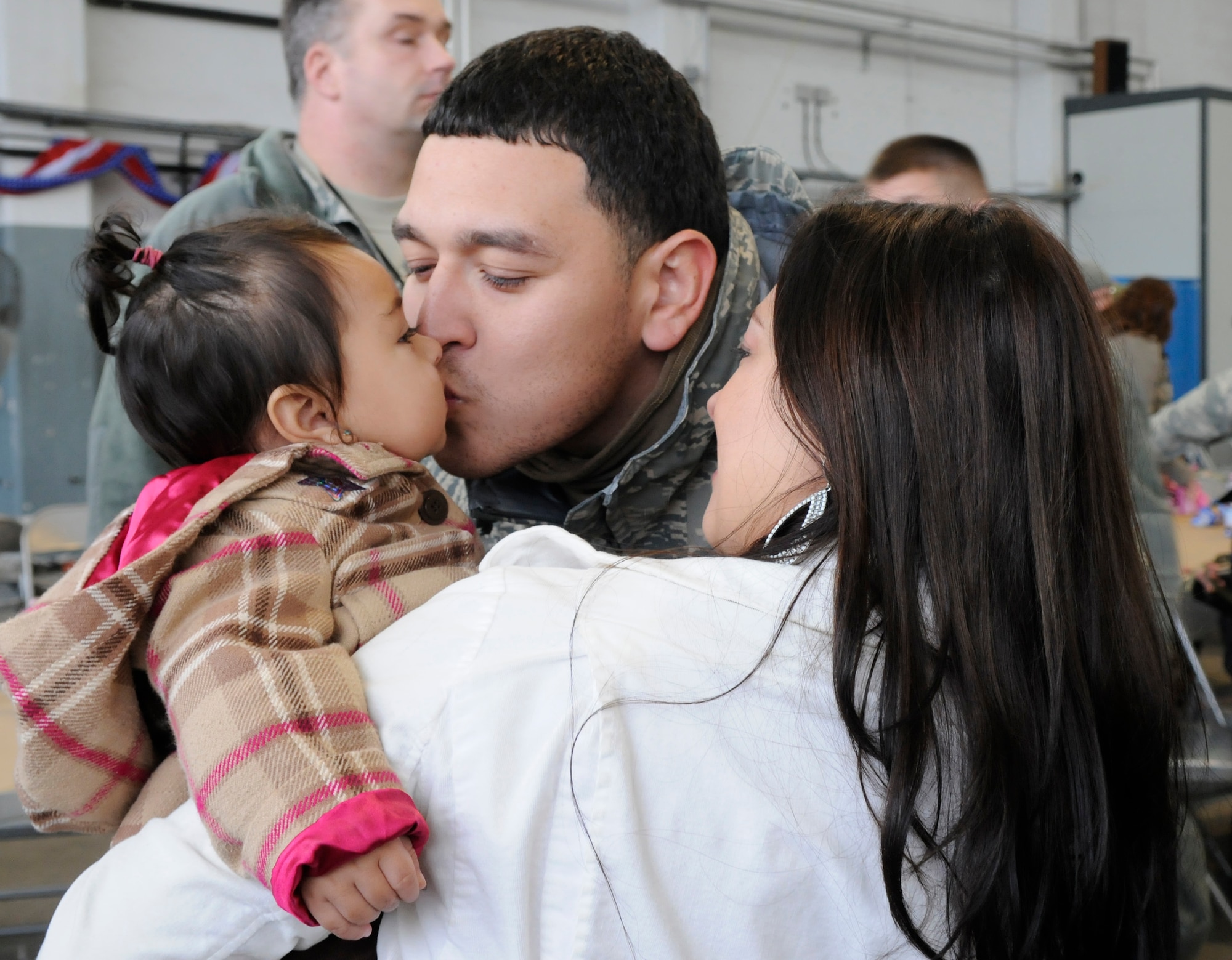 SPANGDAHLEM AIR BASE, Germany – Staff Sgt. Javier Pupiales, 52nd Component Maintenance Squadron, greets his daughter, Madeline, and wife, Rachel, after returning from a four-and-a-half month deployment to Joint Base Balad, Iraq, in support of Operation Iraqi Freedom Feb. 5. The operation supported 1,600 sorties and logged 6,300 flight hours.  (U.S. Air Force photo/Airman 1st Class Staci Miller)