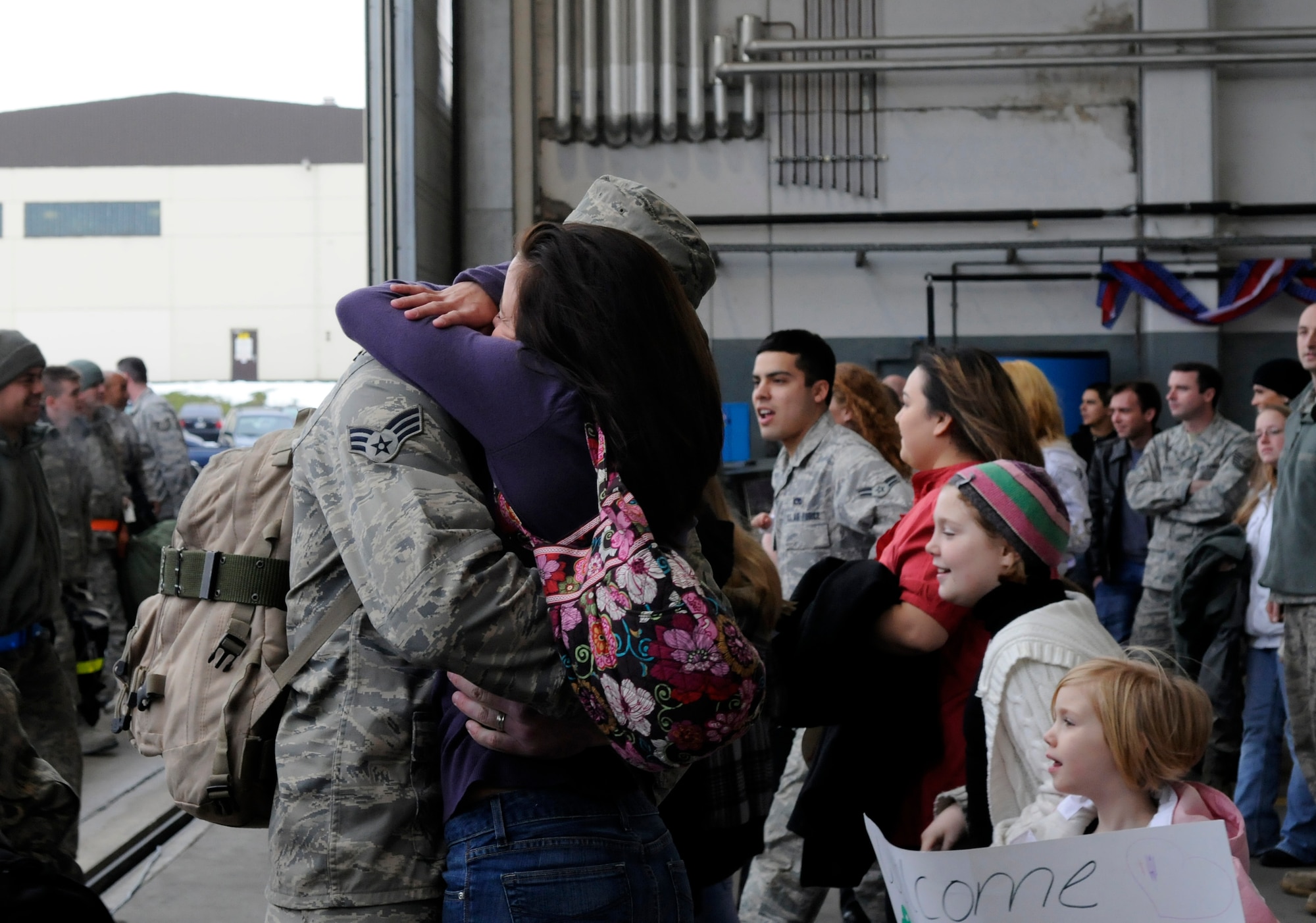 SPANGDAHLEM AIR BASE, Germany – A senior airman greets his wife as family members rush to find their loved ones during a celebration for Sabers returning from a four-and-a-half month deployment to Joint Base Balad, Iraq, in support of Operation Iraqi Freedom Feb. 5.  (U.S. Air Force photo/Airman 1st Class Staci Miller)