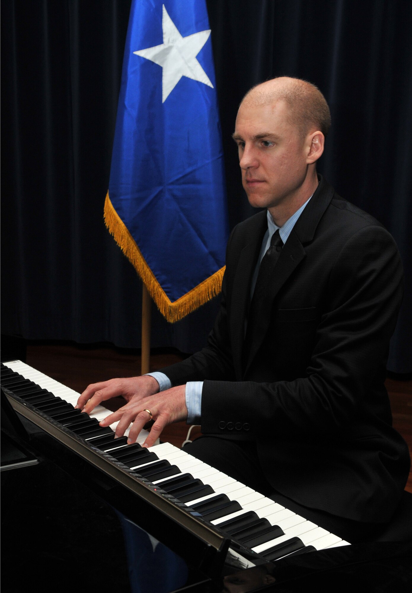 SPANGDAHLEM AIR BASE, Germany -- Pastor Philip Redmond, Trinity Baptist pastor in Metterich, Germany, plays background music during Spangdahlem's 2010 National Prayer Luncheon Jan. 29 at Club Eifel. The national prayer luncheon is an annual interface luncheon that recognizes moral and religious values. (U.S. Air Force photo/Airman 1st Class Nick Wilson)