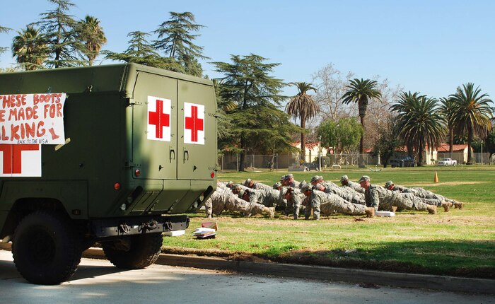 Soldiers complete one last set of push ups at the U.S. Army Reserve's 437th Medical Company Ground Ambulance's Welcome Home Warrior-Citizen Ceremony held at March Air Reserve Base, Calif., Feb. 3, 2010.  The 73 Soldiers in the company deployed to Kuwait on March 2, 2009. (U.S. Air Force photo/Megan Just)