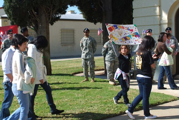 As the family members file into the auditorium, a young girl lingers behind, looking for her mother, a Soldier, at the U.S. Army Reserve's 437th Medical Company Ground Ambulance's Welcome Home Warrior-Citizen Ceremony held at March Air Reserve Base, Calif., Feb. 3, 2010.  The 73 Soldiers in the company deployed to Kuwait on March 2, 2009. (U.S. Air Force photo/Megan Just)