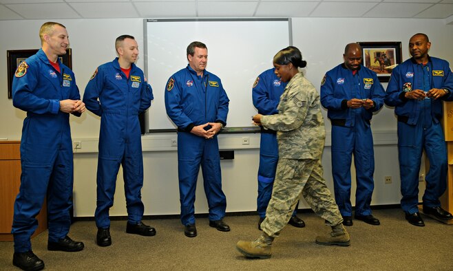 SPANGDAHLEM AIR BASE, Germany – Staff Sgt. Denise Robinson, 52nd Force Support Squadron, presents astronauts from the STS-129 international space station mission with Pitsenbarger Airman Leadership School coins Feb. 3. The astronauts spoke with students of Spangdahlem’s ALS and First Term Airman Center about their recent mission during their visit to Spangdahlem Air Base. (U.S. Air Force photo/Senior Airman Benjamin Wilson)