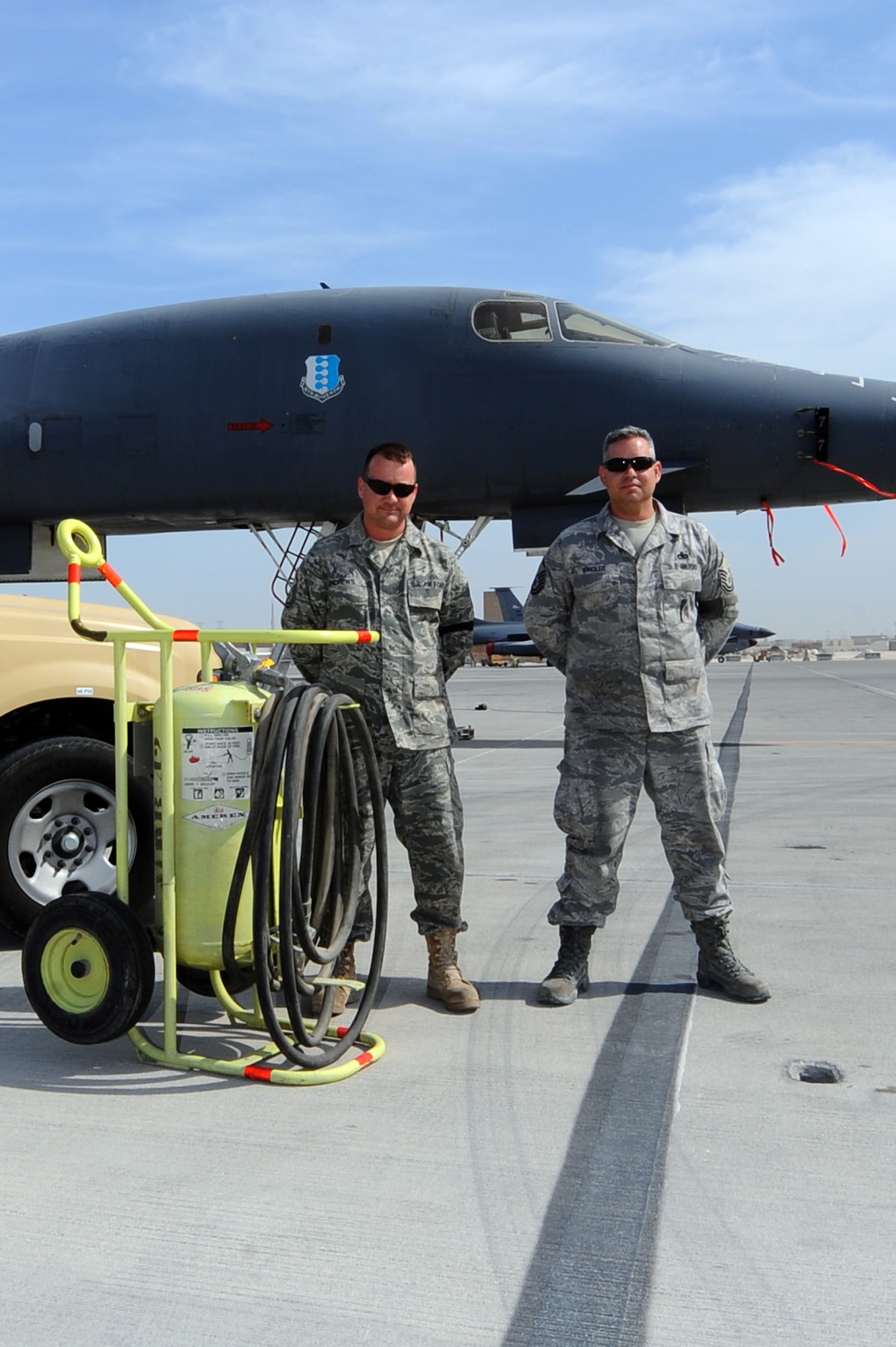 Master Sgts. Alan Andrews (left) and Michael Wingler stand in front of the B-1B Lancer that they saved alongside the rescue equipment Jan. 23, 2010, at an air base in Southwest Asia. Their actions ensured the safety of four aircrew members and prevented the possible destruction of a munitions-loaded aircraft at the base Asia Jan. 28, 2010. Sergeants Andrews and Wingler are both 37th Aircraft Maintenance Unit production supervisors. (U.S. Air Force photo/Senior Airman Kasey Zickmund)