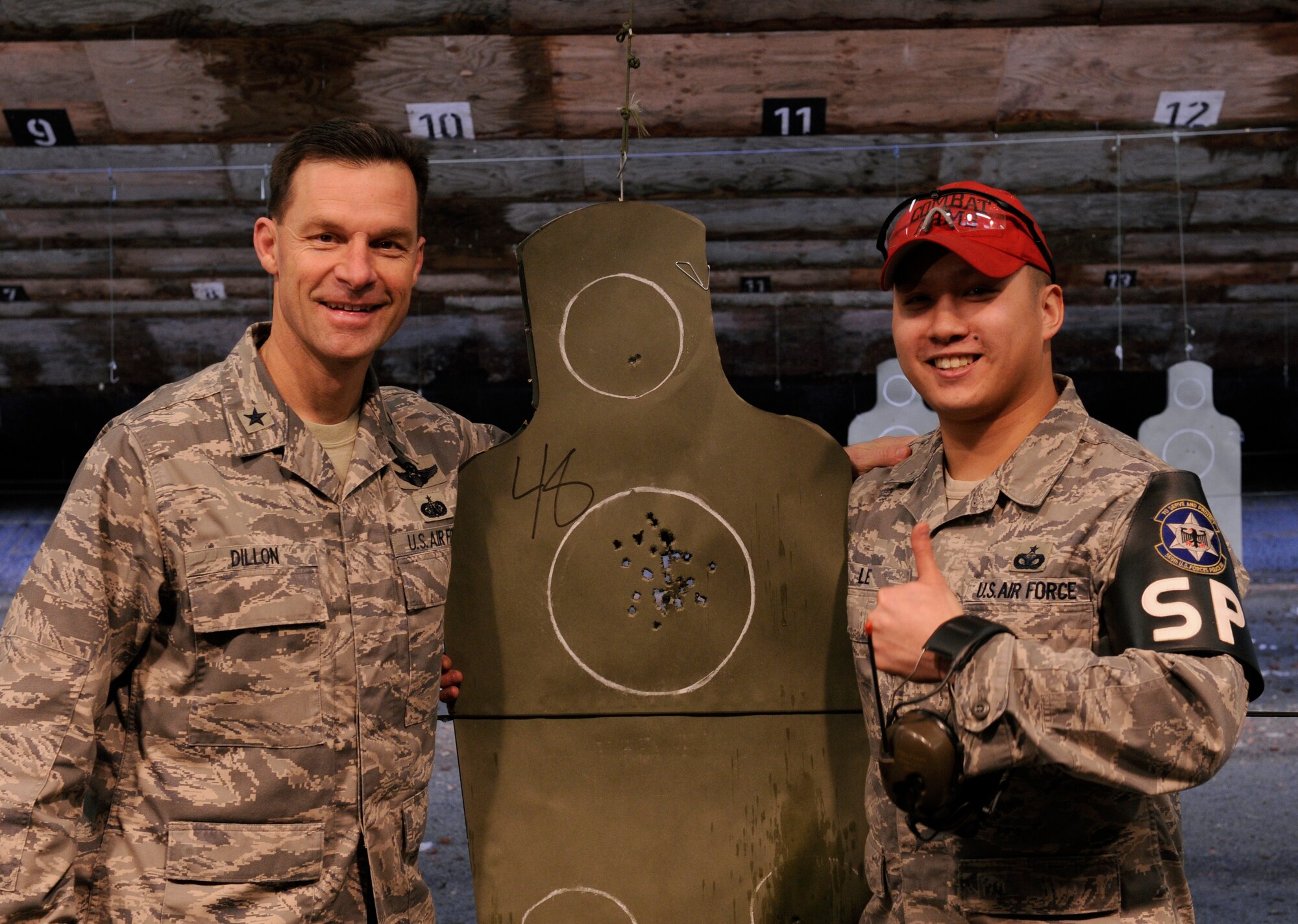 U.S. Air Force Brigadier Gen. Mark Dillon, 86th Airlift Wing commander, poses with winner, Staff Sgt. Dean Le, a Combat Arms Training and Maintenance officer, 569th US Forces Police Squadron at the Combat Arms Training and Maintenance range on Vogelweh Air Base, Germany, Feb. 4, 2010. Sgt. Le was the winner of the M-9 Marksmanship qualification competition. (U.S. Air Force photo by Airman 1st Class Brea Miller)