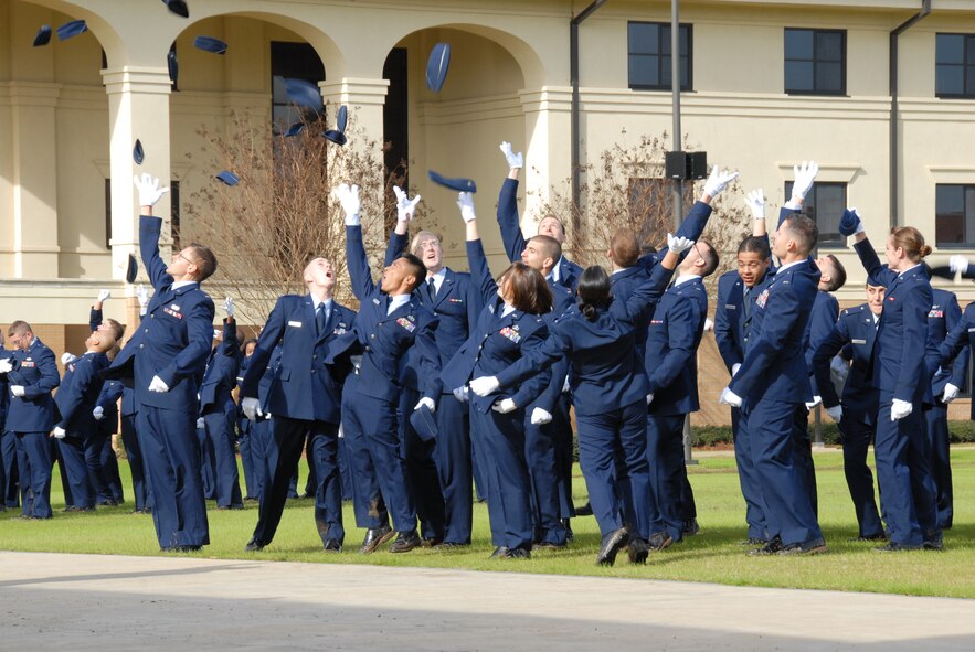 Jubilant graduates from a recent class of the Holm Center Officer Training School throw their caps into the air. Today OTS begins a three-day celebration of its 50th anniversary. A retreat ceremony honoring alumni who were killed or missing in action takes place today at 4 p.m. and a 5K run takes place Saturday at 7 a.m. The run is open to valid military ID holders and their dependents; a golf tournament follows at 8 a.m. at the Maxwell courses. (Air Force photo by Bennett Rock)