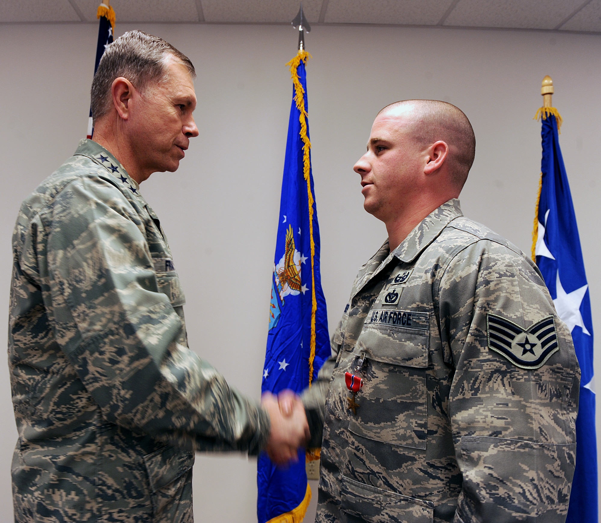 MOODY AIR FORCE BASE, Ga. -- Gen. William M. Fraser III, Air Combat Command commander, shakes the hand of Staff Sgt. Jason Kreider, 23rd Civil Engineering Squadron explosive ordnance disposal craftsman, during a Bronze Star ceremony here Jan. 27. Sergeant Kreider received the medal for his work while deployed. (U.S. Air Force photo by Airman 1st Class Joshua Green)