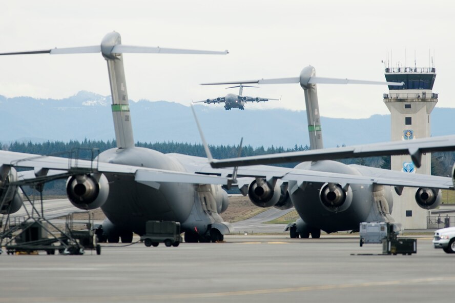 A C-17 Globmaster III piloted by Brig. Gen. Jerry Martinez, Air Mobility Command, Inspector General, makes its final approach to the base Thursday. The aircraft is the newest addition to McChord's fleet of C-17's from the Boeing factory in Long Beach, Calif.(U.S. Air Force Photo/Abner Guzman)
