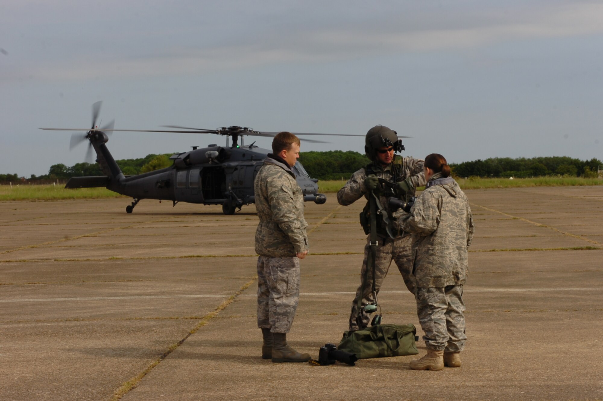 All part of the job, JAC Photographers Staff Sgts. Chad Chisholm and Rachel Goff are briefed before boarding a 56th Rescue Squadron HH-60 helicopter to do aerial photography of RAF Molesworth, RAF Alconbury, and RAF Upwood.  (U.S. Air Force Photo by Stacey Logan)