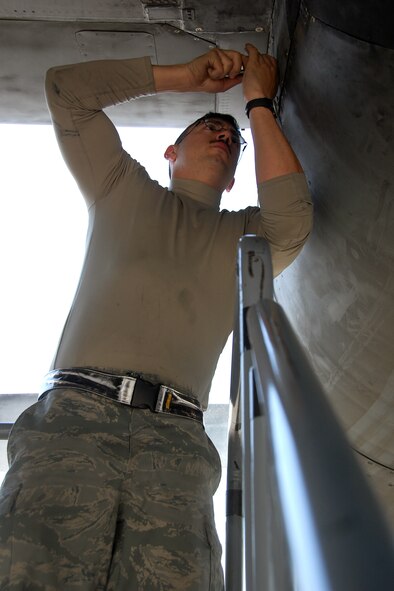 U.S. Air Force Senior Airman Garett Griffith, 386th Expeditionary Aircraft Maintenance Squadron C-130H crew chief, installs screws on a C-130H engine panel Feb. 5, 2010 at an air base in Southwest Asia. Airman Griffith is deployed from Dyess Air Force Base, Texas. (U.S. Air Force photo by Staff Sgt. Lindsey Maurice/Released)