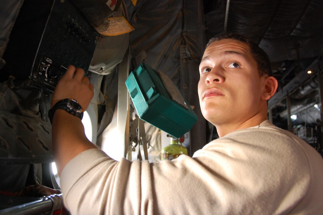 U.S. Air Force Airman 1st Class Edwin Rodriguez, 386th Expeditionary Aircraft Maintenance Squadron C-130H crew chief, makes sure the cargo dome lights in a C-130 work after replacing the reostat knob Feb. 5, 2010 at an air base in Southwest Asia. Airman Rodriguez is deployed from Dyess Air Force Base, Texas. (U.S. Air Force photo by Staff Sgt. Lindsey Maurice/Released)