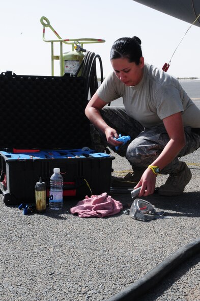 U.S. Air Force Senior Airman Rebecca Roa, 386th Expeditionary Aircraft Maintenance Squadron C-130H crew chief, gathers the necesssary tools to check the prop servicing on a C-130H Feb. 5, 2010 at an air base in Southwest Asia. Airman Roa is deployed from Dyess Air Force Base, Texas. (U.S. Air Force photo by Staff Sgt. Lakisha A. Croley/Released)