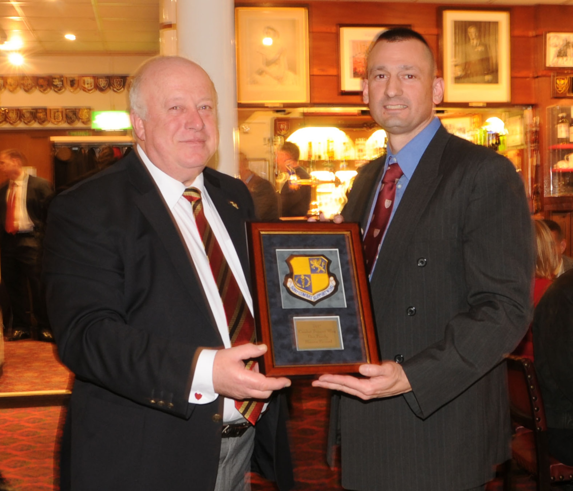 RAF ALCONBURY, United Kingdom - Colonel Timothy Cashdollar (right), 501st Combat Support Wing commander, presented a plaque to the Yeoman Warder's Mess as a token of appreciation after the tour at the Tower of London. More than 40 leaders and their spouses from the 501st Combat Support Wing here traveled to the Tower of London as part of a leadership conference Feb. 3 to learn more about British history and culture. The three-day conference, called "Face2Face," kicked off Wednesday with a tour of the Tower of London and viewing of the Ceremony of the Keys, the traditional locking of the tower each night. The conference helps unite all commanders, command chiefs and first sergeants across the wing in a "face to face" format to discuss future challenges, enhance continuity and promote new ideas for 2010.