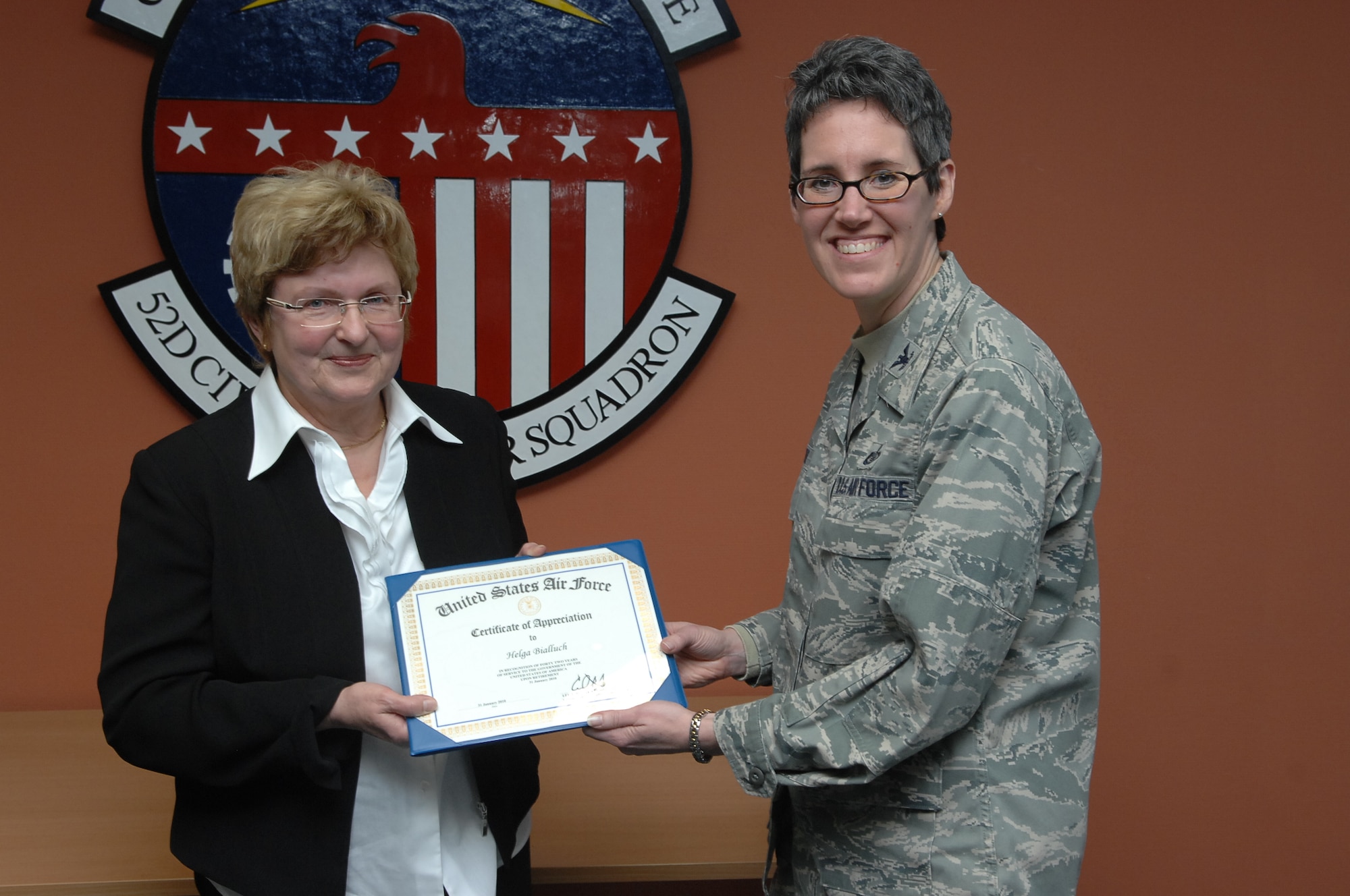 SPANGDAHLEM AIR BASE, Germany -- Col. Jodine Tooke, 52nd Mission Support Group commander, presents a certificate of appreciation to Helga E. Bialluch, retired 52nd Civil Engineer Squadron manpower technician, for her 43 years of dedication and service to Spangdahlem Air Base during her retirement ceremony Jan. 29 in the 52nd CES conference room. Mrs. Bialluch's job was significant to the Air Force and 52nd Fighter Wing because she was responsible for all 52nd CES manpower resources. (U.S. Air Force photo/Airman 1st Class Nick Wilson)