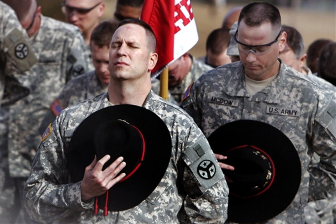 U.S. Army soldiers hold a memorial service on Camp Shelby, Hattiesburg, Miss., Jan. 28, 2010, to honor 14 fallen comrades who gave their lives while serving in Iraq in 2004 and 2005.  The ceremony included the unveiling of a granite monument to the fallen heroes of the 278th Armored Cavalry Regiment, Tennessee Army National Guard.