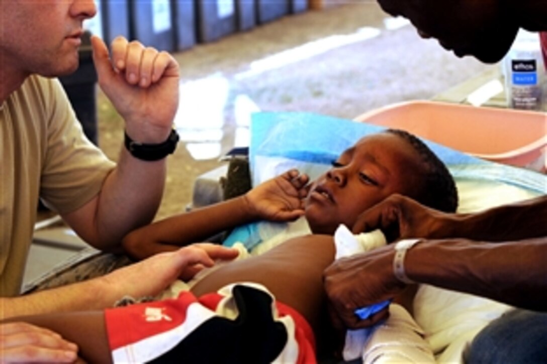 U.S. Army Capt. Buddy Davis provides medical care to an earthquake survivor in Port-Au-Prince, Haiti, Feb. 4, 2010. An earthquake hit Haiti Jan. 12, 2010, leaving thousands of residents homeless and without access to food, water and vital medical care.