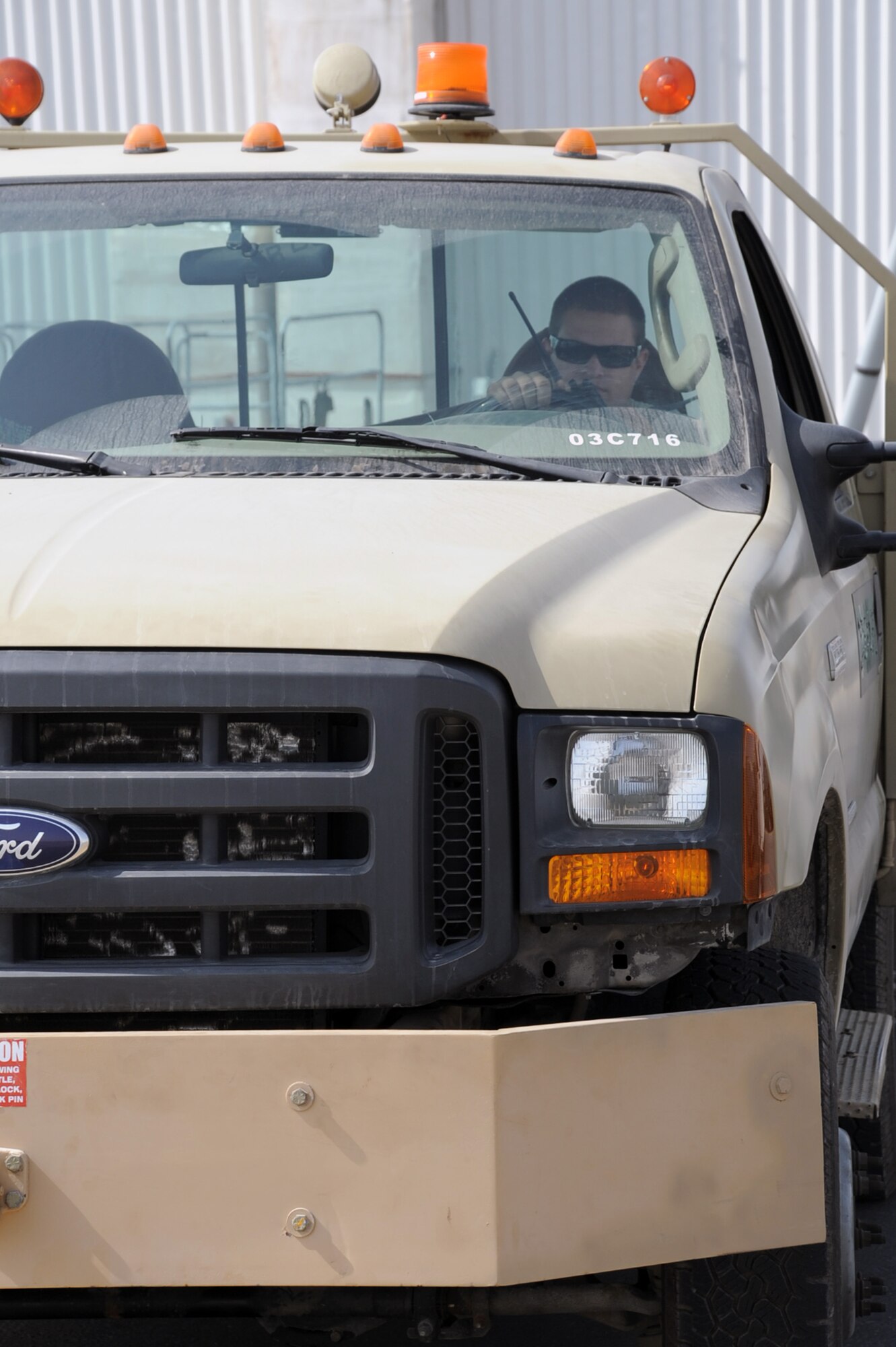 An Airman assigned to the 380th Expeditionary Aircraft Maintenance Squadron talks on his radio while parked in a maintenance truck on the flightline of a non-disclosed base in Southwest Asia on Feb. 1, 2010. Maintenance Airmen run shifts 24 hours a day supporting flying operations for the 380th Air Expeditionary Wing.  (U.S. Air Force Photo/Master Sgt. Scott T. Sturkol/Released)