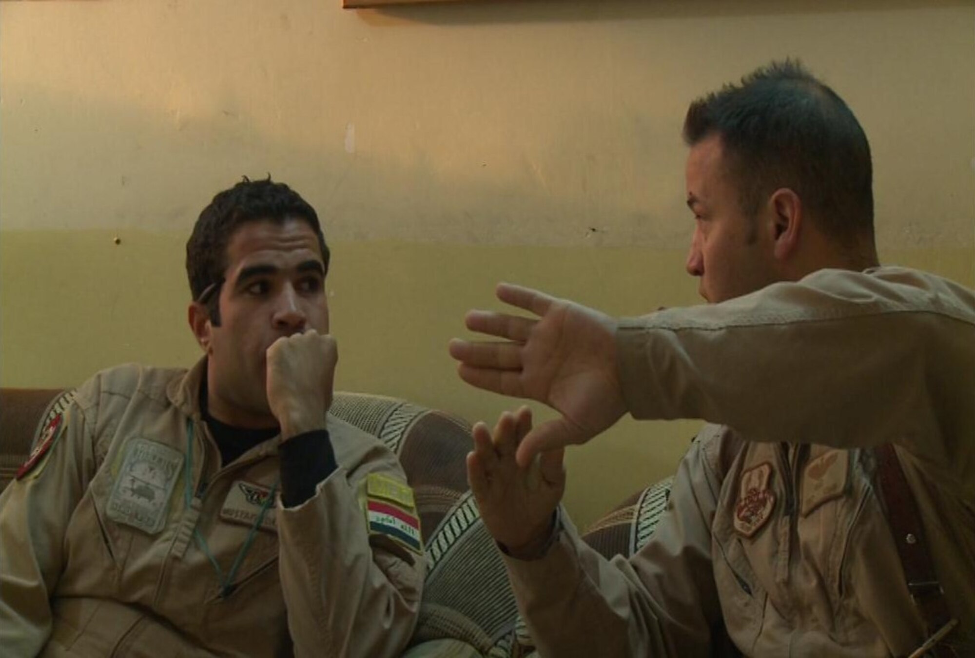 U.S. Air Force Tech. Sgt. Onnez Rodriguez-Massas, an aerial gunner for the 721st  Air Expeditionary Advisory Squadron, talks tactics with an Iraqi aerial gunner in a briefing before a mission at Camp Taji, Iraq, Jan. 28, 2010. The overall objective of U.S. Air Force aerial gunners in the 721st Air Expeditionary Advisory Squadron is to train Iraqi aerial gunners on techniques, procedures and aircrew discipline so that Iraq can develop a self sustaining air force capable of protecting its people. (Courtesy photo)