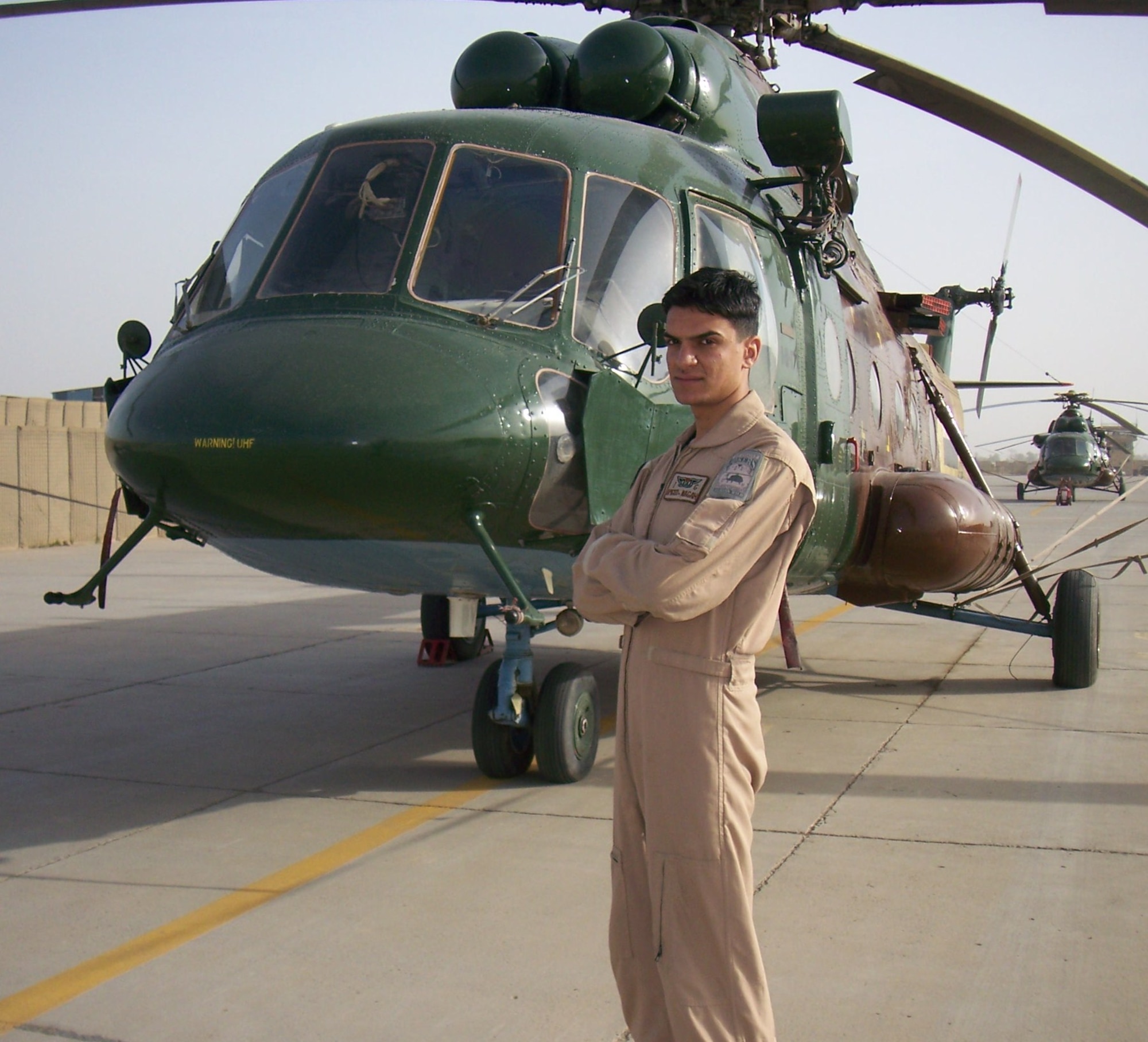 Amjad Njaah Mjeed, an Iraqi air force aerial gunner, poses in front of a Mi-17 helicopter at Camp Taji, Iraq, Jan. 29, 2010, in which the Iraqis use to train, conduct and perform missions. The overall objective of U.S. Air Force aerial gunners in the 721st Air Expeditionary Advisory Squadron is to train Iraqi aerial gunners on techniques, procedures and aircrew discipline so that Iraq can develop a self sustaining air force capable of protecting its people. (Courtesy photo)