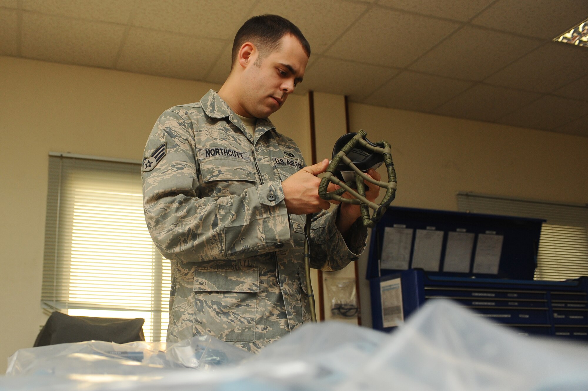 Senior Airman Thomas Northcutt, 379th Expeditionary Operations Support Squadron aircrew flight equipment journeyman, inspects an aircrew flight mask at a non-disclosed Southwest Asia location Feb. 3, 2010. (U.S. Air Force photo by Senior Airman Kasey Zickmund)[RELEASED]