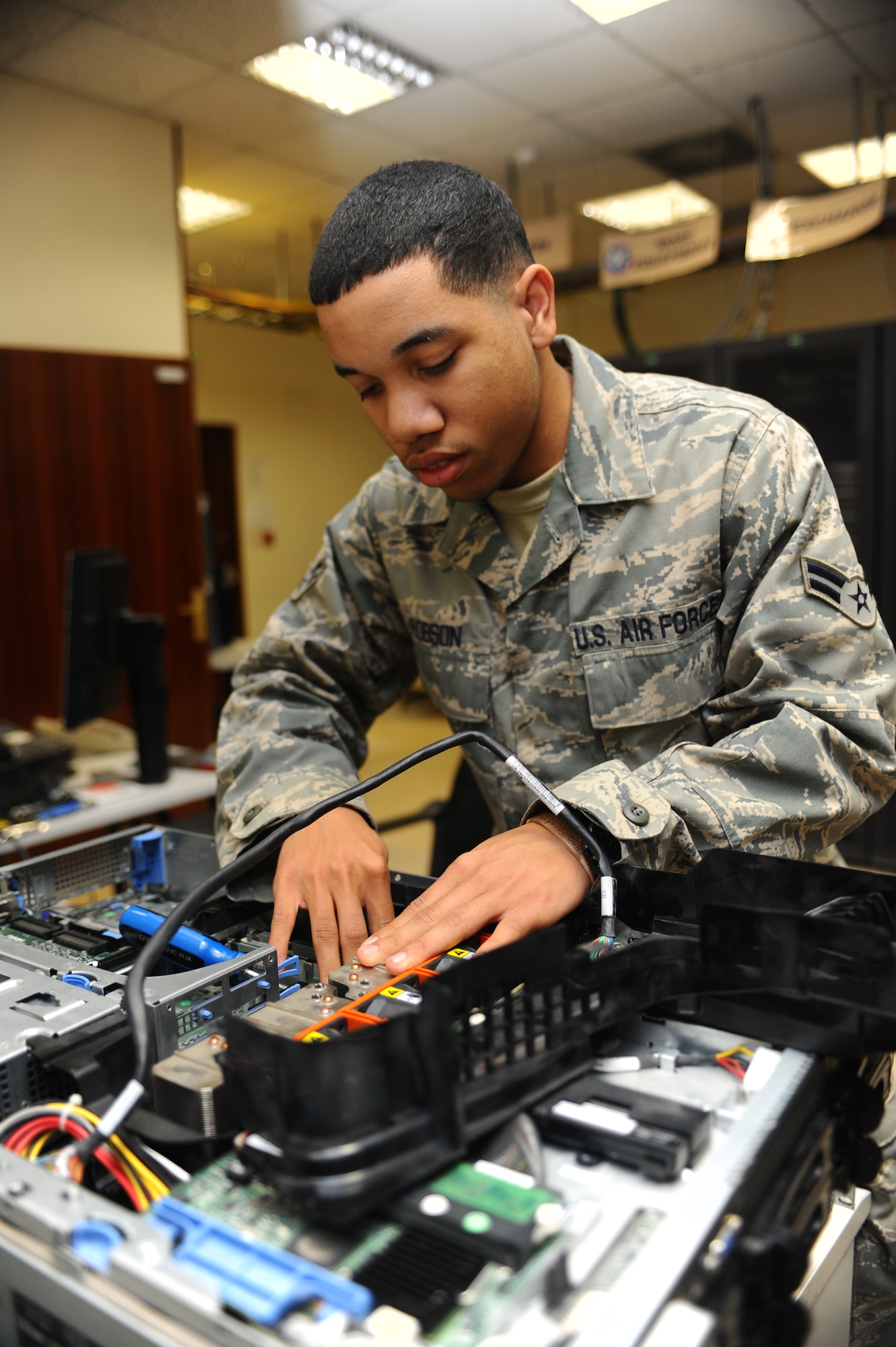 Airman 1st Class Jonathan Robson, 379th Expeditionary Communication Squadron computer system operator, repairs a computer server at a non-disclosed Southwest Asia location Jan. 27, 2010. Airman Robson has been accepted to attend the U.S. Air Force Academy and will head there July 1. (U.S. Air Force photo by Senior Airman Kasey Zickmund)[RELEASED]