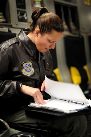 U.S. Air Force Capt. Erika Meyers reviews technical orders during pre-flight checks before takeoff aboard a C-17 Globemaster III here Feb. 4, 2010. The flight was part of a routine training mission geared toward perfecting the skills and knowledge required to perform aerial duties. Captain Meyers is a pilot with the 17th Airlift Squadron. (U.S. Air Force photo by Tech. Sgt. William Greer)