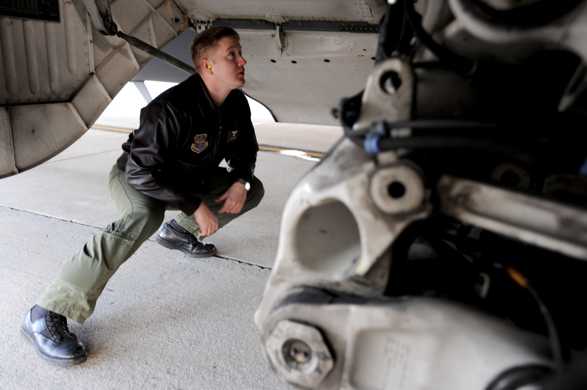 U.S. Air Force Capt. Brad Bowyer inspects the landing gear of a C-17 Globemaster III here Feb. 4, 2010. Prior to each mission, the aircrew inspects aircraft maintenance documentation and performs a visual check of the aircraft to ensure it is ready for flight. Captain Bowyer is a pilot with the 17th Airlift Squadron. (U.S. Air Force photo by Tech. Sgt. William Greer)