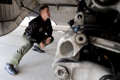 U.S. Air Force Capt. Brad Bowyer inspects the landing gear of a C-17 Globemaster III here Feb. 4, 2010. Prior to each mission, the aircrew inspects aircraft maintenance documentation and performs a visual check of the aircraft to ensure it is ready for flight. Captain Bowyer is a pilot with the 17th Airlift Squadron. (U.S. Air Force photo by Tech. Sgt. William Greer)