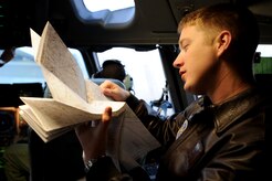 U.S. Air Force Capt. Brad Bowyer reviews his maps and flight plan in preparation for takeoff aboard a C-17 Globemaster III here Feb. 4, 2010. The mission was flown as part of an evaluation to keep aircrew skills sharp and ready to perform duties anywhere, anytime. Captain Bowyer is a pilot with the 17th Airlift Squadron. (U.S. Air Force photo by Tech. Sgt. William Greer)