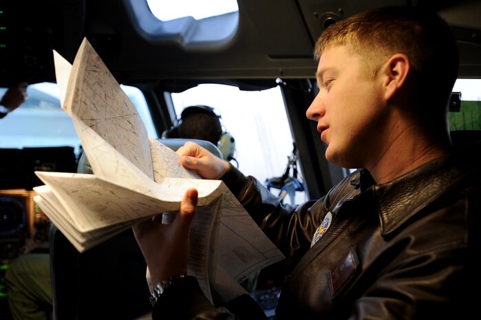 U.S. Air Force Capt. Brad Bowyer reviews his maps and flight plan in preparation for takeoff aboard a C-17 Globemaster III here Feb. 4, 2010. The mission was flown as part of an evaluation to keep aircrew skills sharp and ready to perform duties anywhere, anytime. Captain Bowyer is a pilot with the 17th Airlift Squadron. (U.S. Air Force photo by Tech. Sgt. William Greer)