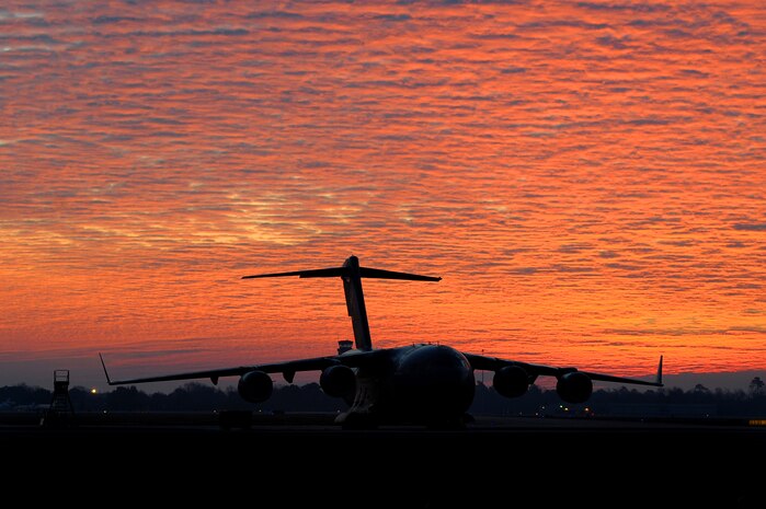 A C-17 Globemaster III sits on the parking ramp at Joint Base Charleston during a sunrise Feb. 4, 2010, before an evaluation flight. More than 50 aircraft are assigned to the base and are flown during execution of training and real-world missions 24 hours a day, seven days a week, providing airlift, air delivery, aeromedical evacuation and humanitarian aid. (U.S. Air Force photo by Tech. Sgt. William Greer)