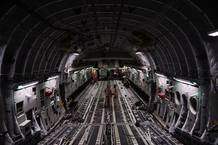 C-17 Globemaster III loadmasters, assigned to the 816th Expeditionary Airlift Squadron, take a break from re-stowing gear used to secure 60,000 pounds of supplies air-dropped over Afghanistan, Feb. 1, 2010.  (U.S. Air Force photo/Staff Sgt. Manuel J. Martinez/released)
