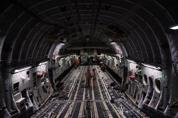 C-17 Globemaster III loadmasters, assigned to the 816th Expeditionary Airlift Squadron, take a break from re-stowing gear used to secure 60,000 pounds of supplies air-dropped over Afghanistan, Feb. 1, 2010.  (U.S. Air Force photo/Staff Sgt. Manuel J. Martinez/released)