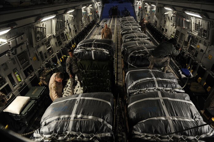 U.S. Air Force C-17 Globemaster III loadmasters and U.S. Army Soldiers load forty containerized-delivery-system bundles of food and water, to be air-dropped to a forward-operating base in Afghanistan, Feb. 1, 2010, at Bagram Air Base, Afghanistan. The loadmasters are assigned to the 816th Expeditionary Airlift Squadron and the Soldiers are assigned to the 612th Quartermaster Detachment.  (U.S. Air Force photo/Staff Sgt. Manuel J. Martinez/released)