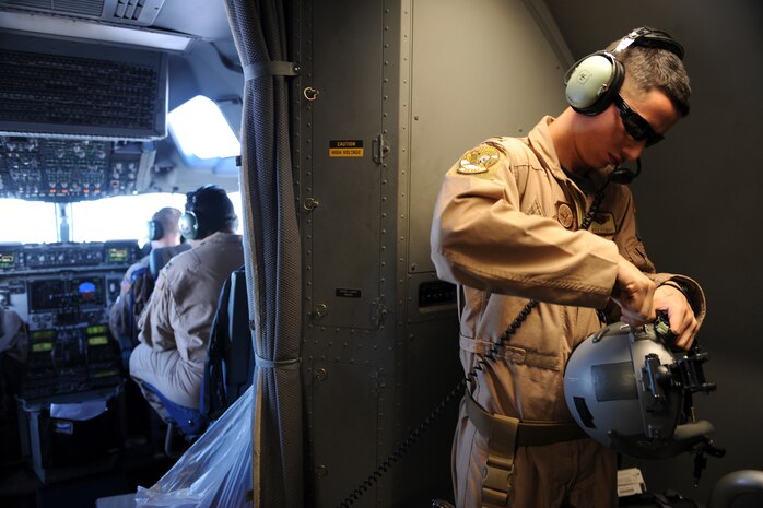 First Lieutenant Kyle J. Stewart, a C-17 Globemaster III pilot assigned to the 816th Expeditionary Airlift Squadron, prepares his flight helmet during a cargo-transportation mission to Afghanistan, Feb. 1, 2010, over Southwest Asia. Pilots plan and prepare for missions, brief other aircrew members and ensure aircraft are pre-flighted and ready.  (U.S. Air Force photo/Staff Sgt. Manuel J. Martinez/released)